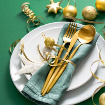 Gold cutlery served on plate for Christmas Dinner