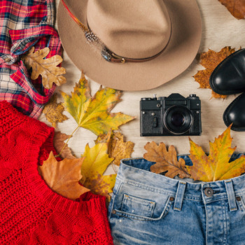flat lay of woman style and accessories, red knitted sweater, checkered shirt, denim jeans, black leather boots, hat, autumn fashion trend, view from above, clothes, yellow leaves